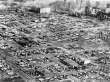 An aerial photo of a cityscape that has been razed almost entirely to the ground. 