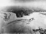 An aerial photo of the coast of the Potomac River, which has overflowed onto the land and covered some structures.