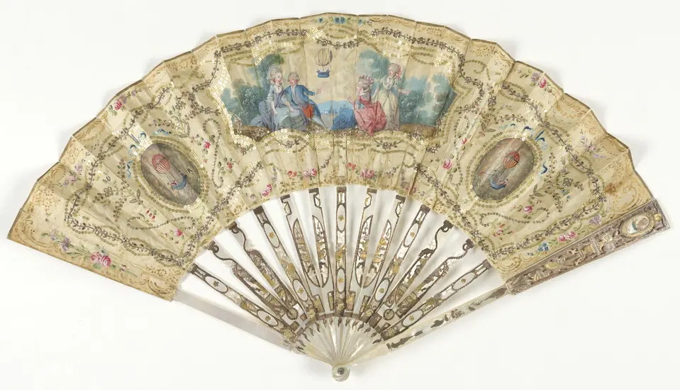 Ornate, pearl decorative fan from the eighteenth century with depictions of the first hydrogen balloon launch.